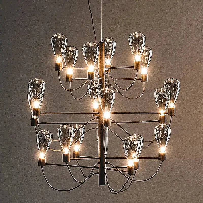 A contemporary iron glass chandelier with multiple clear glass bulb shades and a tiered black metal frame