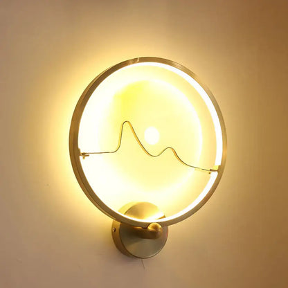 Contemporary jade and gold ring wall lamp with circular brass finish wall mount and elegant mountain wire design