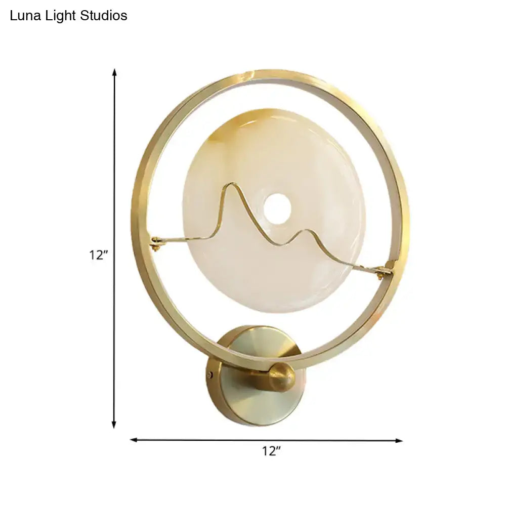 Contemporary jade and gold ring wall lamp with gold-toned circular wall mount and frosted glass shade with wavy design