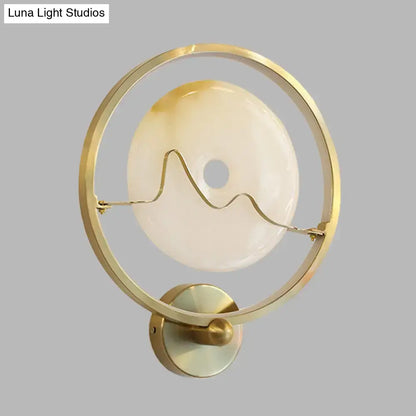 Contemporary wall lamp gold ring with jade and cream opaline glass disc and elegant wavy wire design wall mount