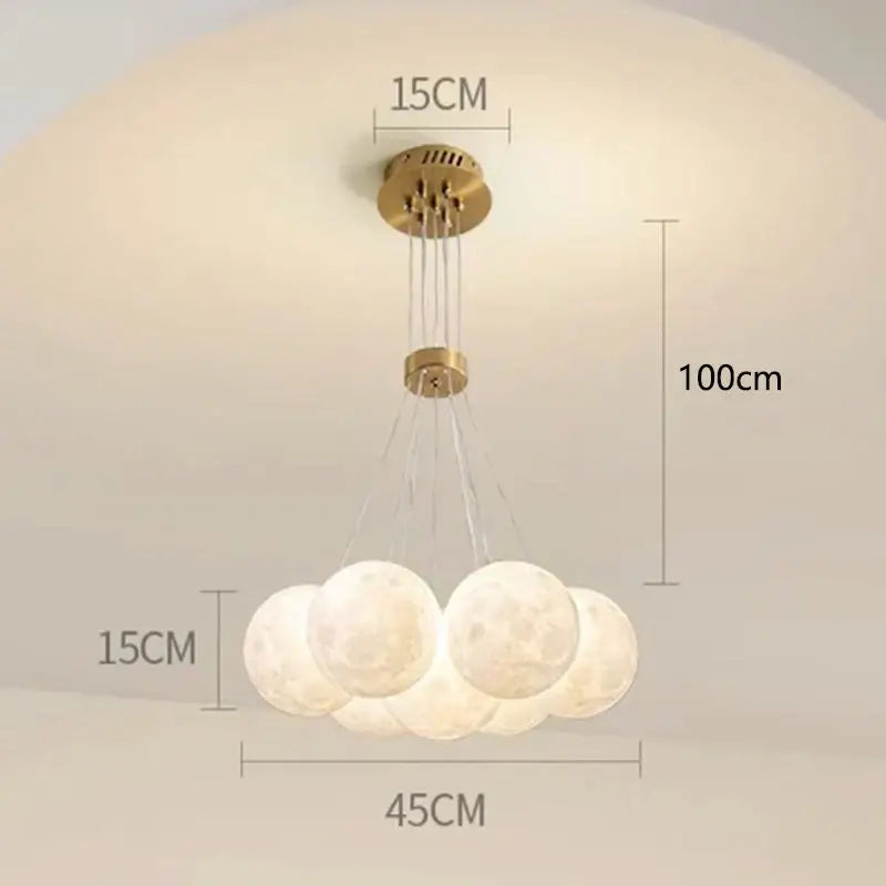 A decorbites contemporary led pendant light with five frosted moon-like bulbs and a brass finish for dining room decor