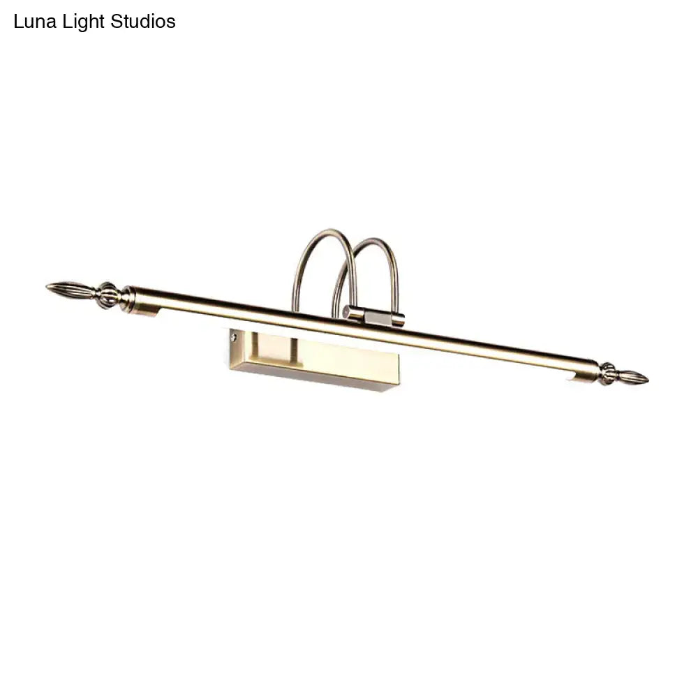 Contemporary nickel finish wall sconce with brushed brass curved arches and pointed finials providing warm light