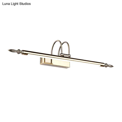 Contemporary nickel finish wall sconce with brushed brass curved arches and pointed finials providing warm light