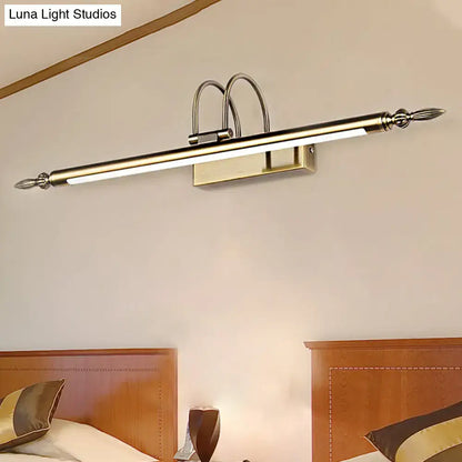 Modern brushed brass wall-mounted vanity light with decorative finials providing warm white nickel finish illumination
