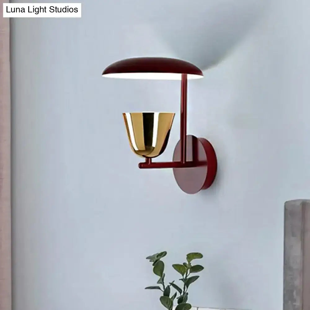 Contemporary red and gold wall sconce with sleek minimalist design for light bedroom use and modern wall-mounted decor