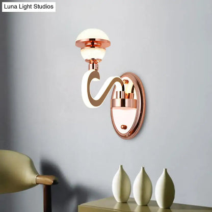 Contemporary rose gold metal urn wall lamp with curved glowing white arm and frosted glass globe for bedroom lighting