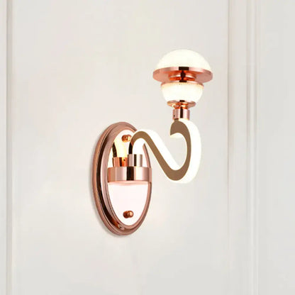 Contemporary rose gold metal urn wall lamp with curved sculpted arm and frosted glass globe shades for bedroom lighting