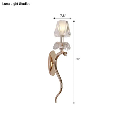 Contemporary rose gold bedroom wall light with gold-toned curved sconce and clear ribbed glass crystal accents