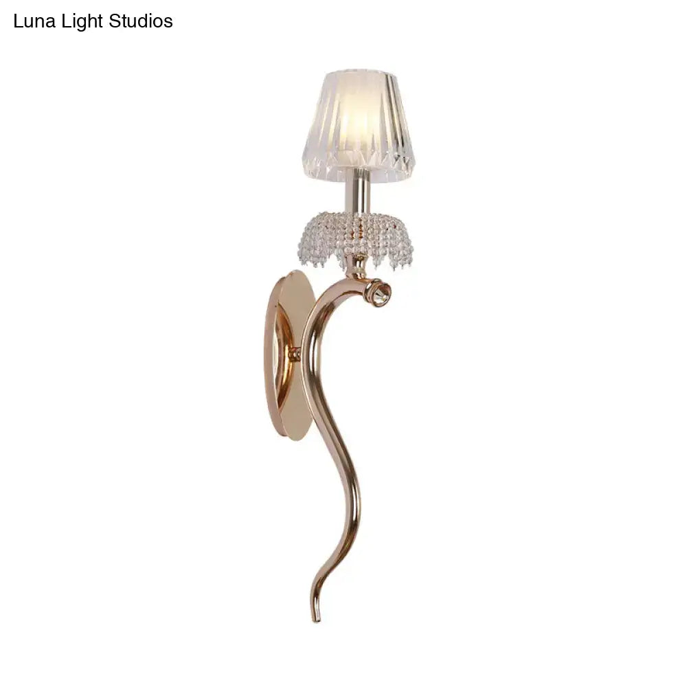 Contemporary rose gold wall sconce with ribbed glass shade and clear ribbed glass crystals for bedroom lighting