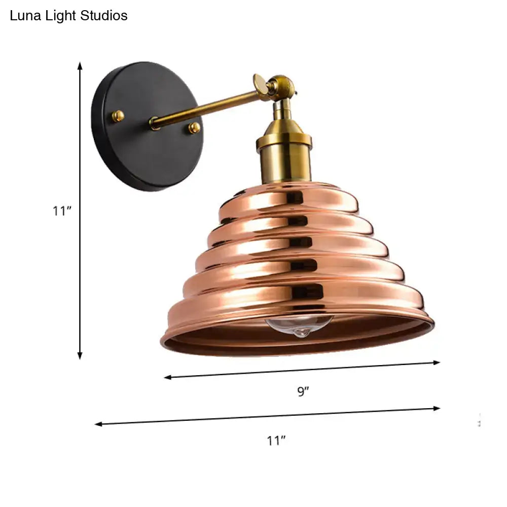 Contemporary rose gold wall sconce with ribbed design metal shade and brass arm for bedroom lighting