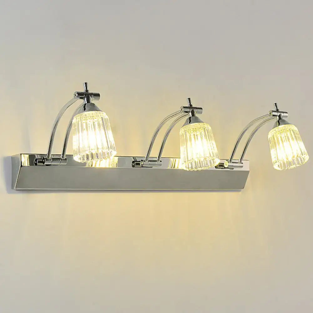 Contemporary silver wall light with three chrome curved arms and faceted crystal shades for vanity light warm white use