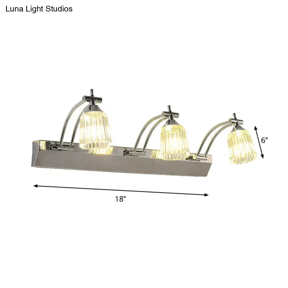 Contemporary silver 3 head crystal vanity light with faceted glass shades emits warm white wall light illumination