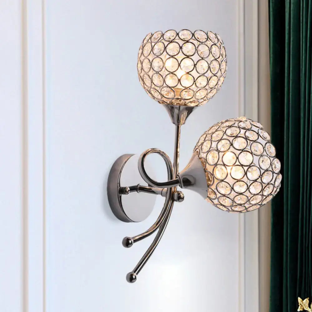 Contemporary silver dual head dome sconce with polished metallic bulb base and crystal circle encrusted shades for bedroom light