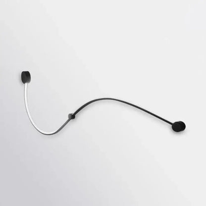 Contemporary twist black and white wall sconce with white warm light and a black and silver headset microphone with flexible gooseneck