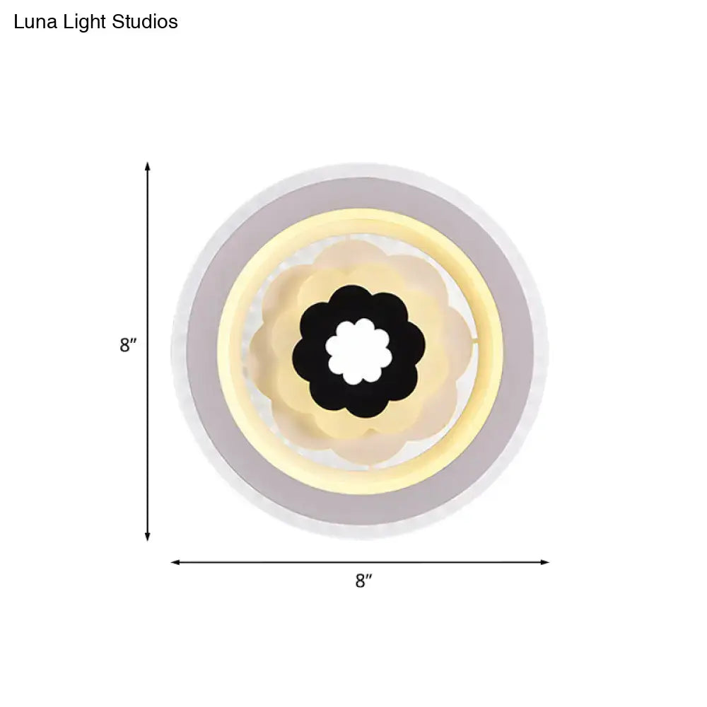 Contemporary white and beige led wall sconce with layered circular design and black flower motif 10 inches fixture