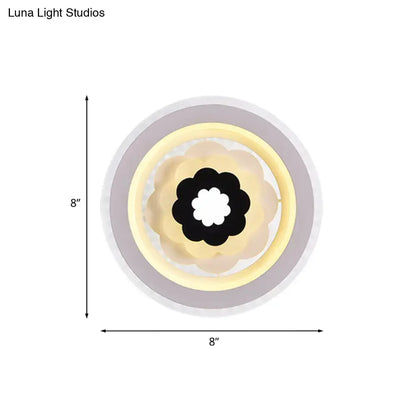 Contemporary white and beige led wall sconce with layered circular design and black flower motif 10 inches fixture