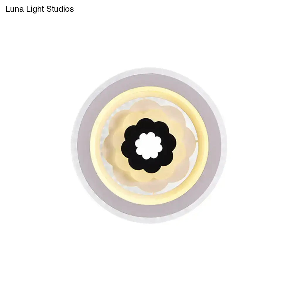 Contemporary white and beige 10 inches fixture led wall sconce with circular concentric rings and black flower center