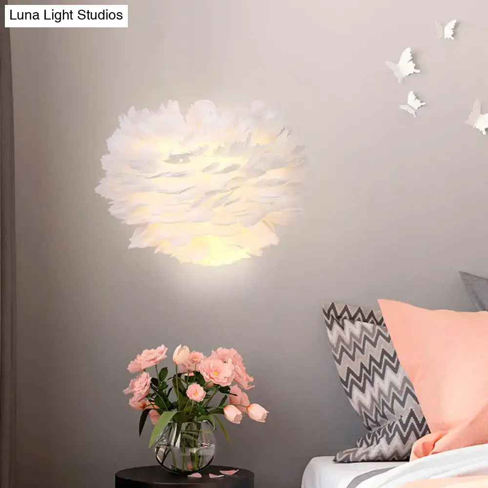 Contemporary white feather wall lamp with soft diffused glow designed as a bedroom sconce