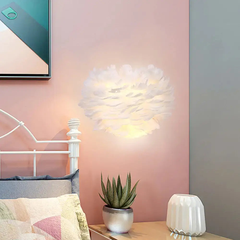 Contemporary white feather wall lamp with soft texture and warm glow for bedroom sconce lighting