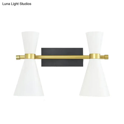 Modern two-light wall sconce with adjustable arm, white conical shades, brass bar, and black rectangular backplate