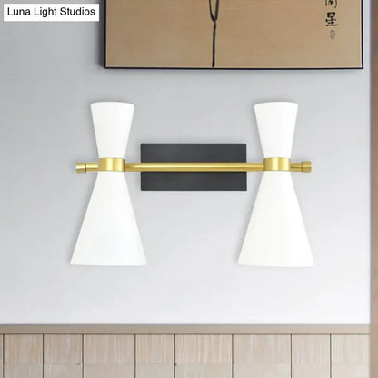 Contemporary white and gold wall sconce with adjustable arm, conical shades, black backplate, and polished brass accents