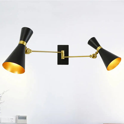Contemporary black and gold double-arm wall sconce with adjustable arms and conical shades for bedroom lighting