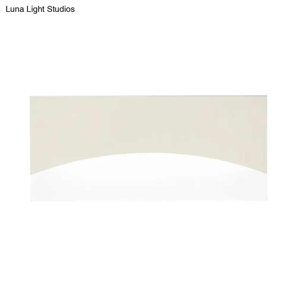 Contemporary white and gold bedroom sconce with beige curved panel, smooth glossy finish, warm color temperature, fixture width visible