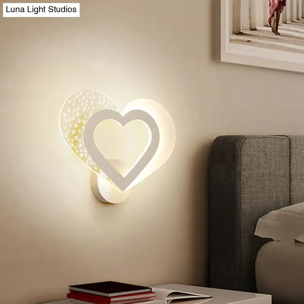 Contemporary white love heart wall mounted light with textured dotted surface and glowing inner frame for bedroom use