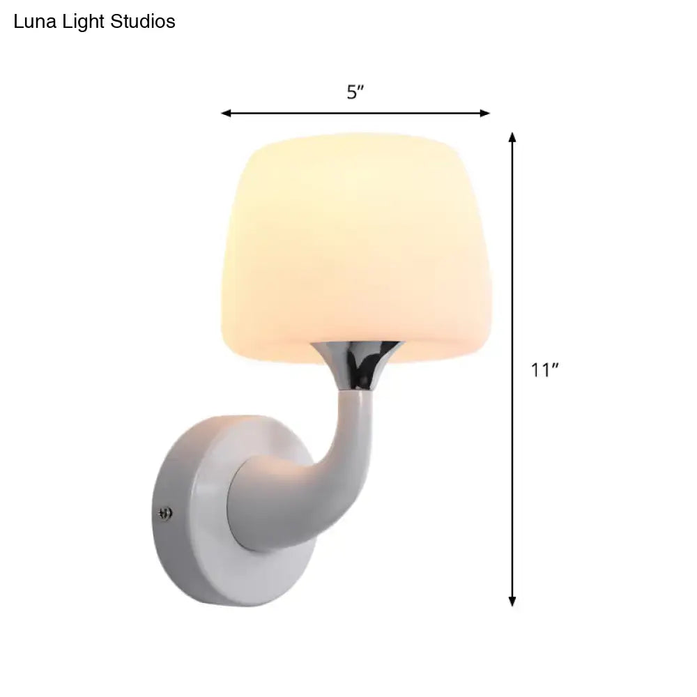 A sleek white contemporary wall light with opal glass shade and curved arm for bedroom light fixture use