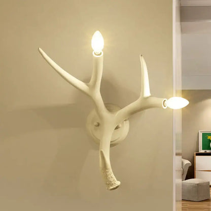 Contemporary white resin antler shaped wall sconce with two illuminated bulbs designed for dining rooms and restaurants