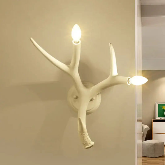 Contemporary white resin antler shaped wall sconce with two illuminated bulbs designed for dining rooms and restaurants