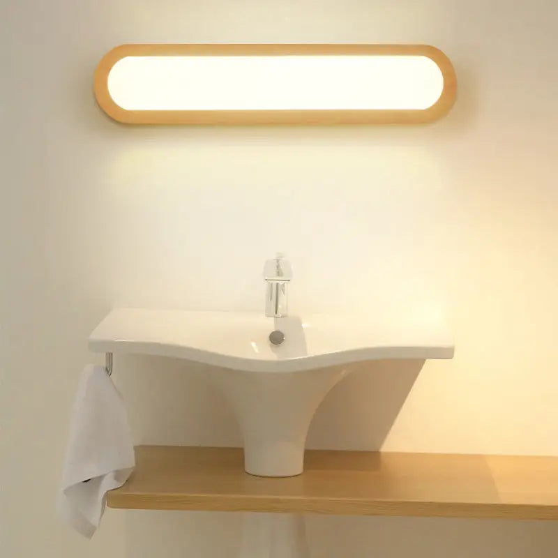 A contemporary led sconce vanity light with an oval wood frame and warm white illumination for bedroom use
