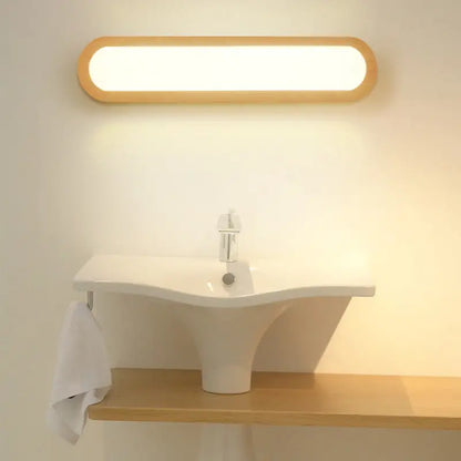 A contemporary led sconce vanity light with an oval wood frame and warm white illumination for bedroom use