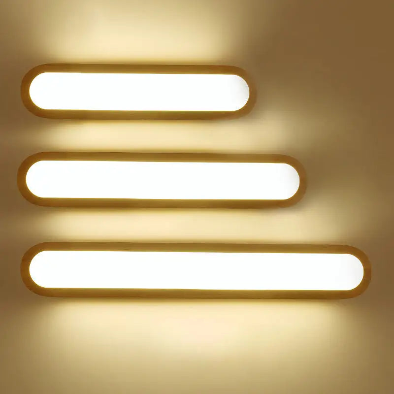 Three contemporary led sconce vanity lights with warm white led and sleek wooden frames for bedroom use