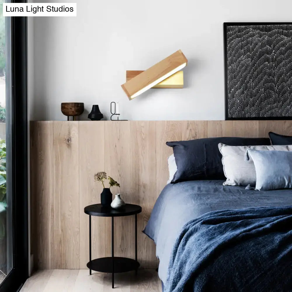 Contemporary wood led wall sconce with acrylic shade featuring a sleek angled wooden design and warm golden accent