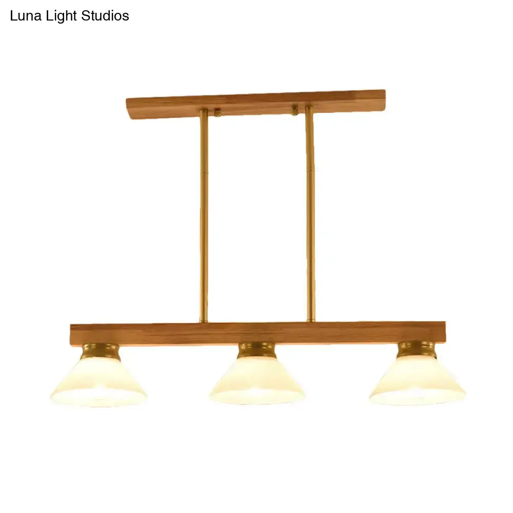 Contemporary wood linear island ceiling light with three frosted glass shades gold black accents for dining room