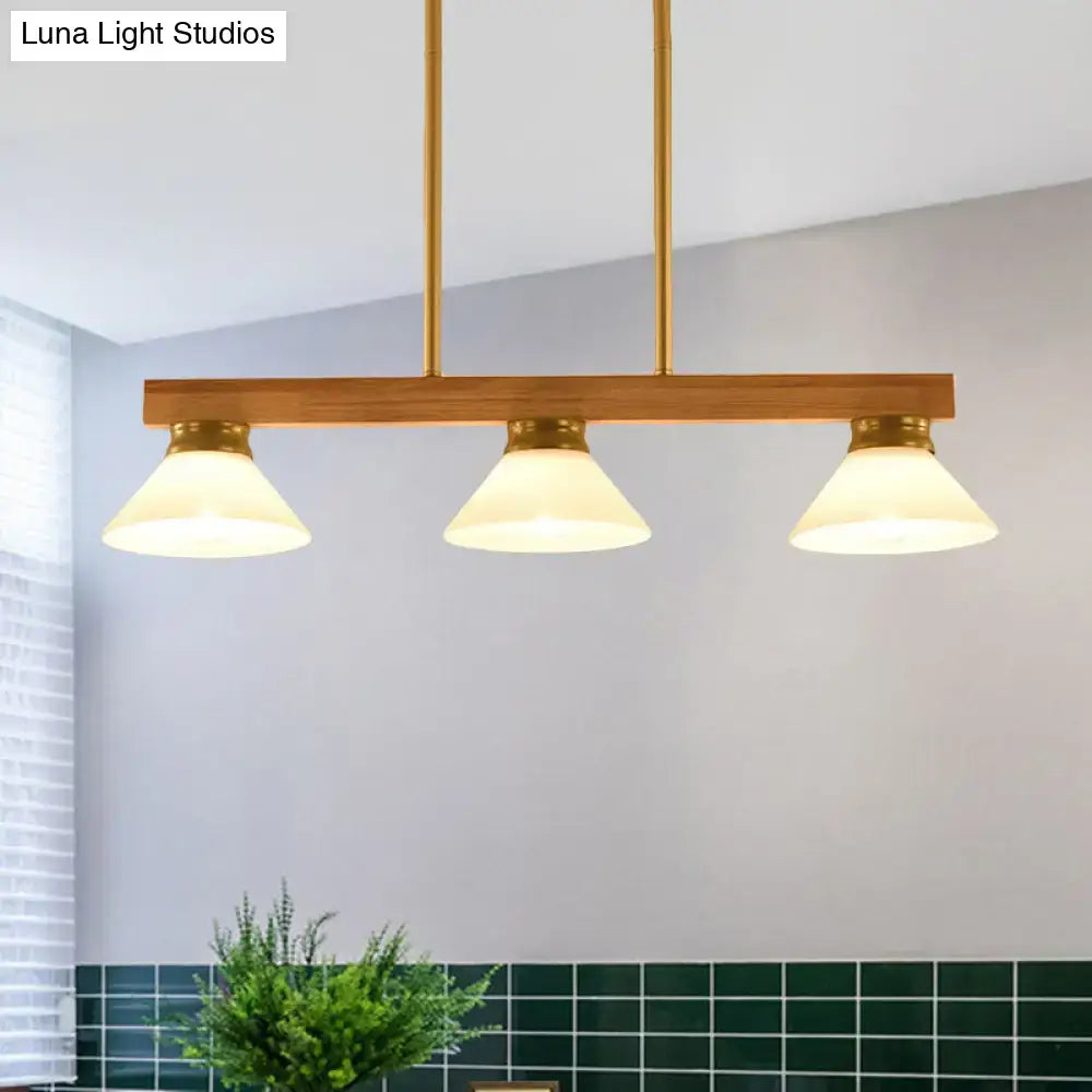 Modern brass and wood linear island ceiling light with three frosted glass shades in gold black for dining room