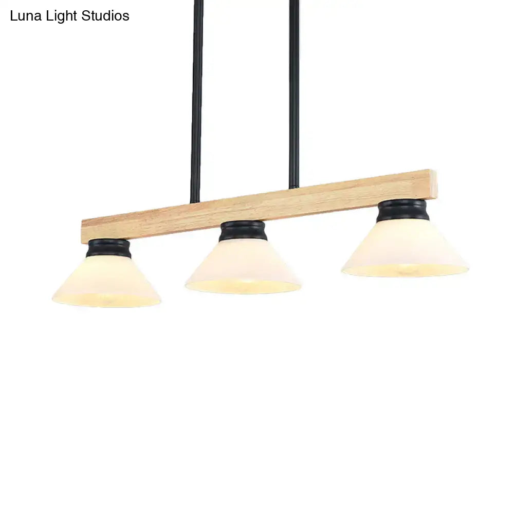 Contemporary wood linear island ceiling light with gold black metal hardware and three frosted glass shades for dining room