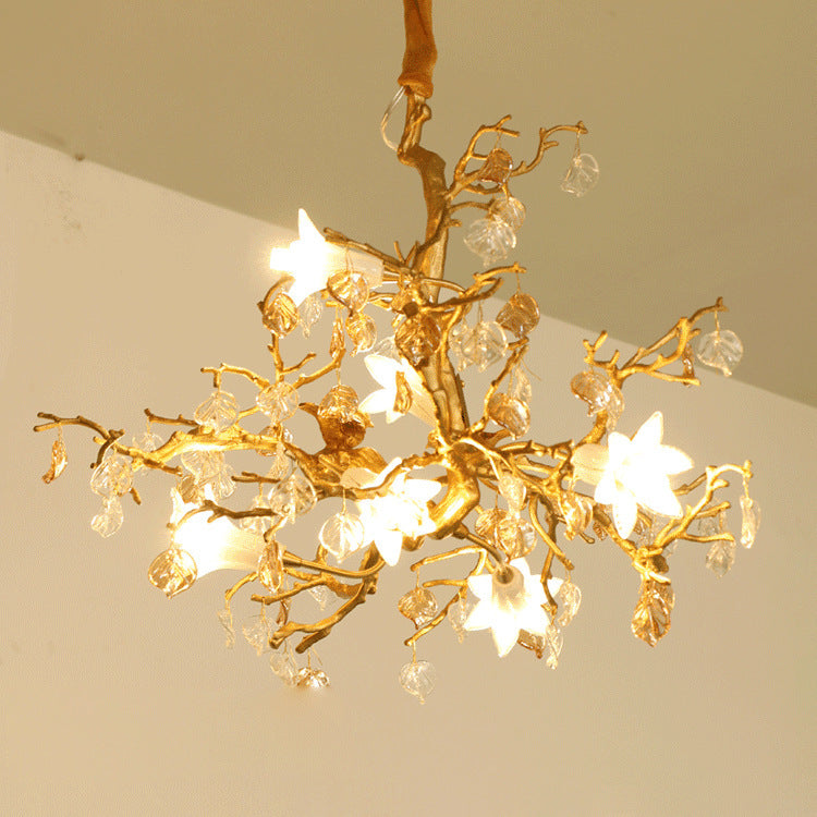Copper branch chandelier featuring a gold tree branch design with crystal accents and star-shaped lights