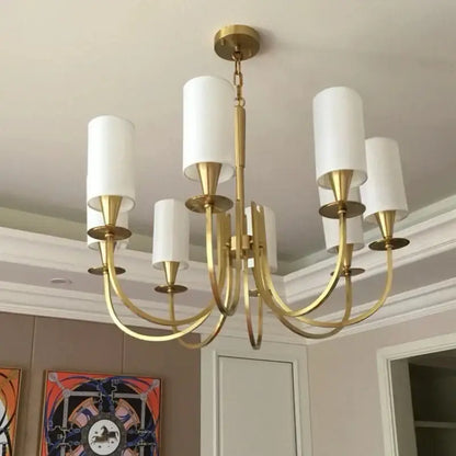 Gold-toned copper ceiling chandelier with five white fabric cylindrical shades for living room decor by decorbites copper ceiling
