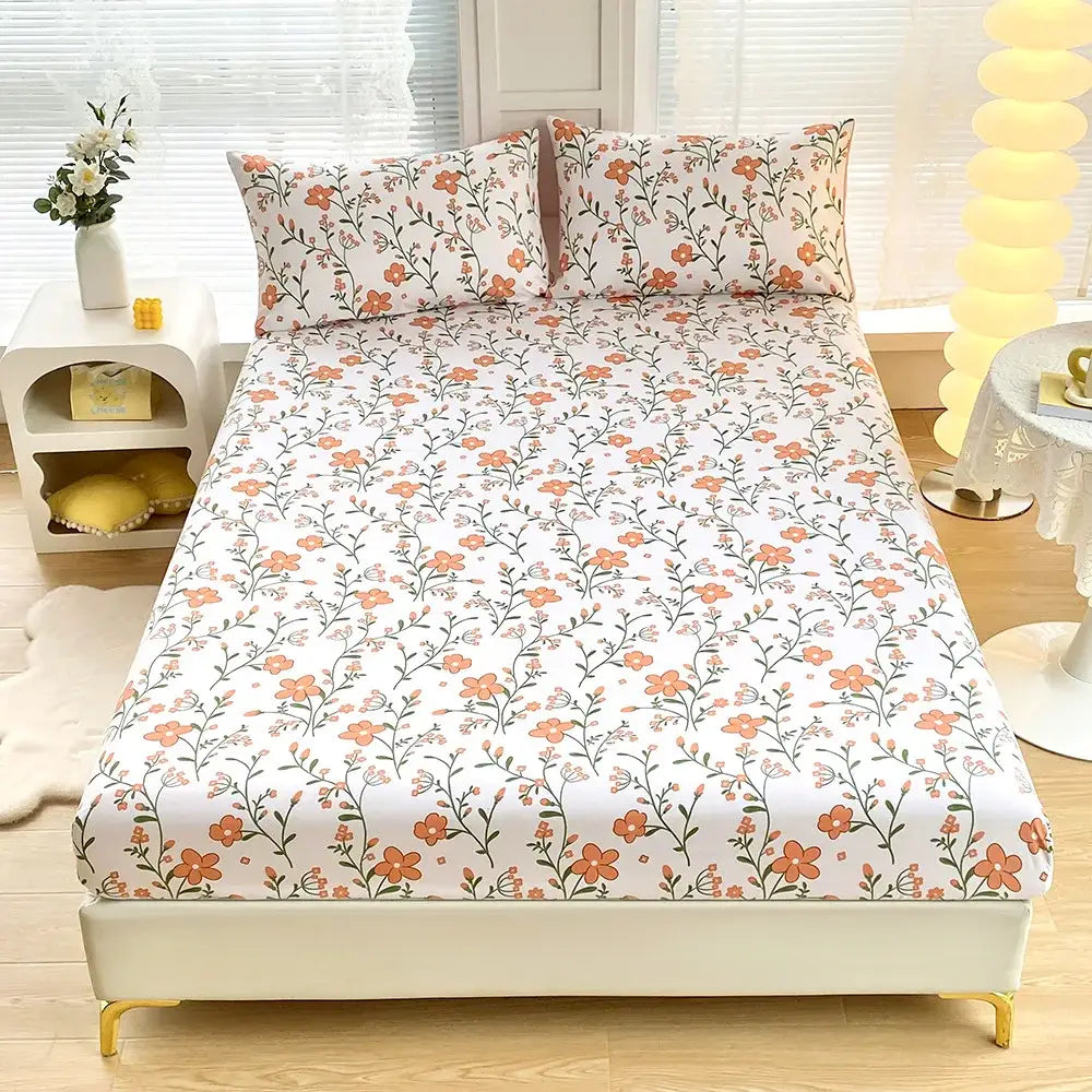 White fitted sheet set with coral and white geometric floral pattern and green leaf flower accents including pillowcases