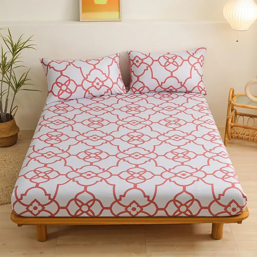 White fitted sheet set with coral red geometric floral pattern featuring interconnected green leaf flower design