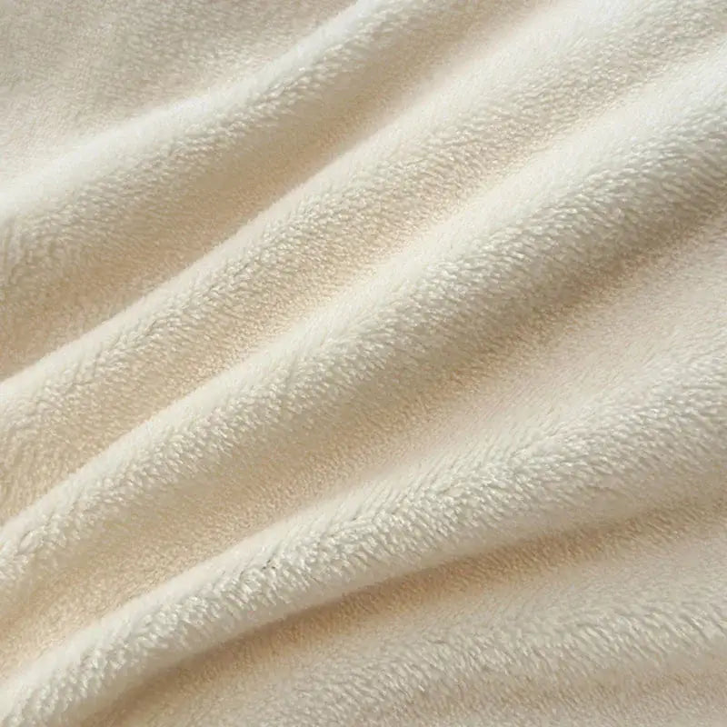 Cream-colored plush fleece blanket with soft textured surface as part of decorbites coral color blocked velvet duvet cover set