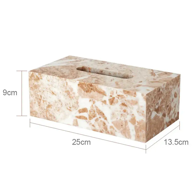 A rectangular tissue box with beige and white marble pattern from decorbites coral pink marble bathroom set with gold accents
