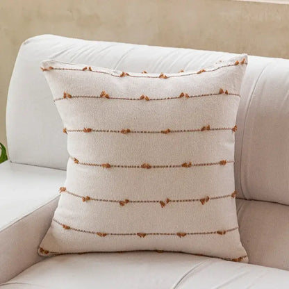 Cream-colored decorbites cotton stripe jacquard throw pillow with brown tassels and dark stitching for living room decor