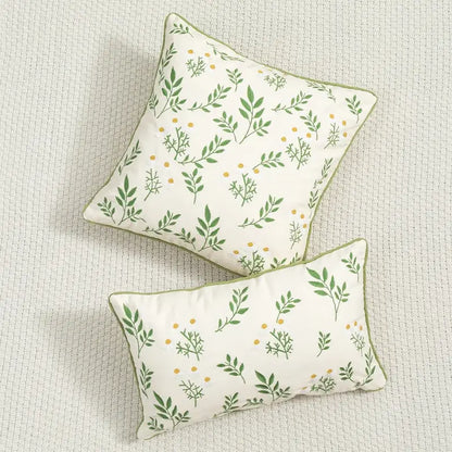 Cream-colored floral embroidered cushion cover with green leaf yellow dot patterns and olive-green trim for living room use