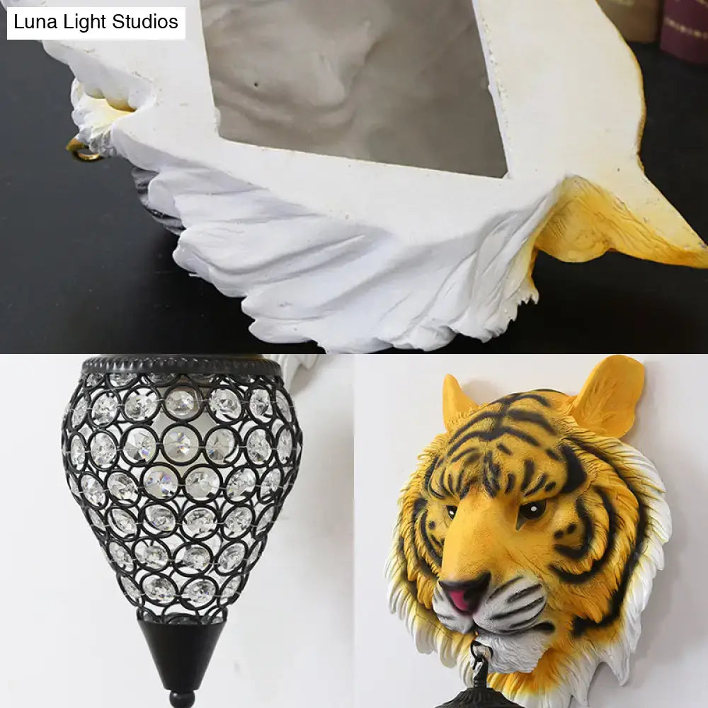 Country tiger head wall sconce with white and yellow tiger design, black stripes, metallic hook, and clear crystal shade