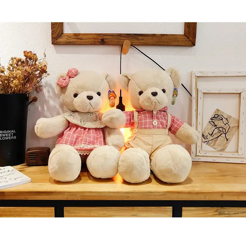 Two cream-colored plush toys from decorbites featuring a couple bear plush dressed for christmas gift giving
