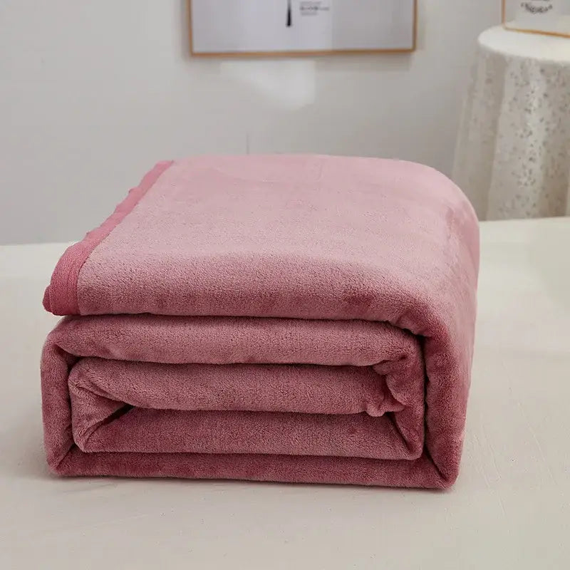 A soft plush pink fleece blanket neatly folded showcasing decorbites cozy checkered fleece throw features