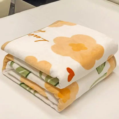 A soft plush white cozy checkered fleece blanket with orange green flowers and gold lulu embroidery for bedroom decorbites
